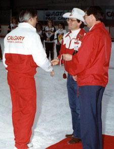 Committee Member Erik Laerz presents a gold medal to fellow committee member and Junior Coach Gerry Preuter.