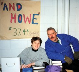 Ringette Calgary Board Members Laura Webb and Paul Peters work the table selling "And Howe" books.